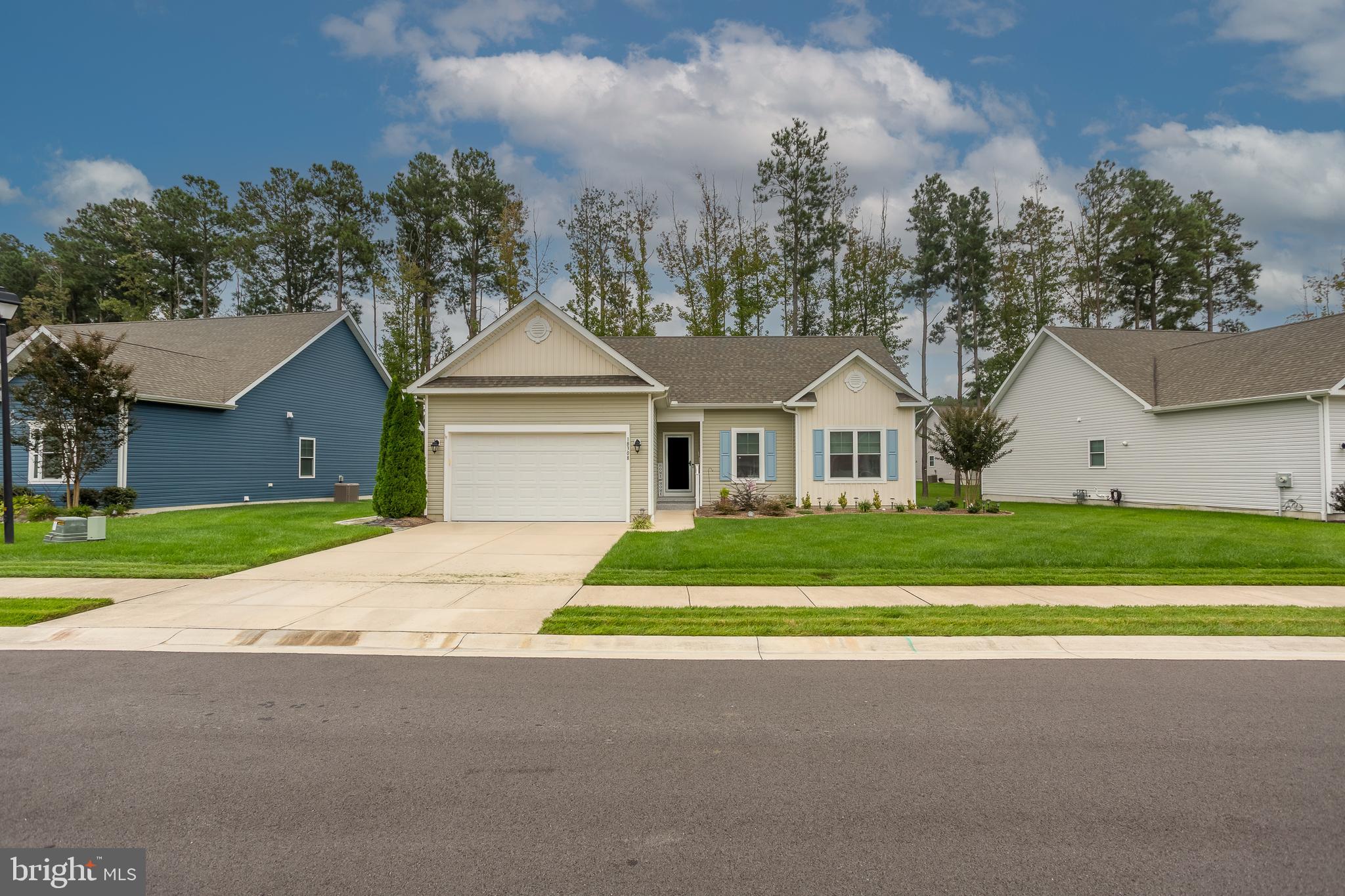 18308 Emerson Way Georgetown, DE 19947 - Photo 1 of 43 a front view of a house with a yard and garage