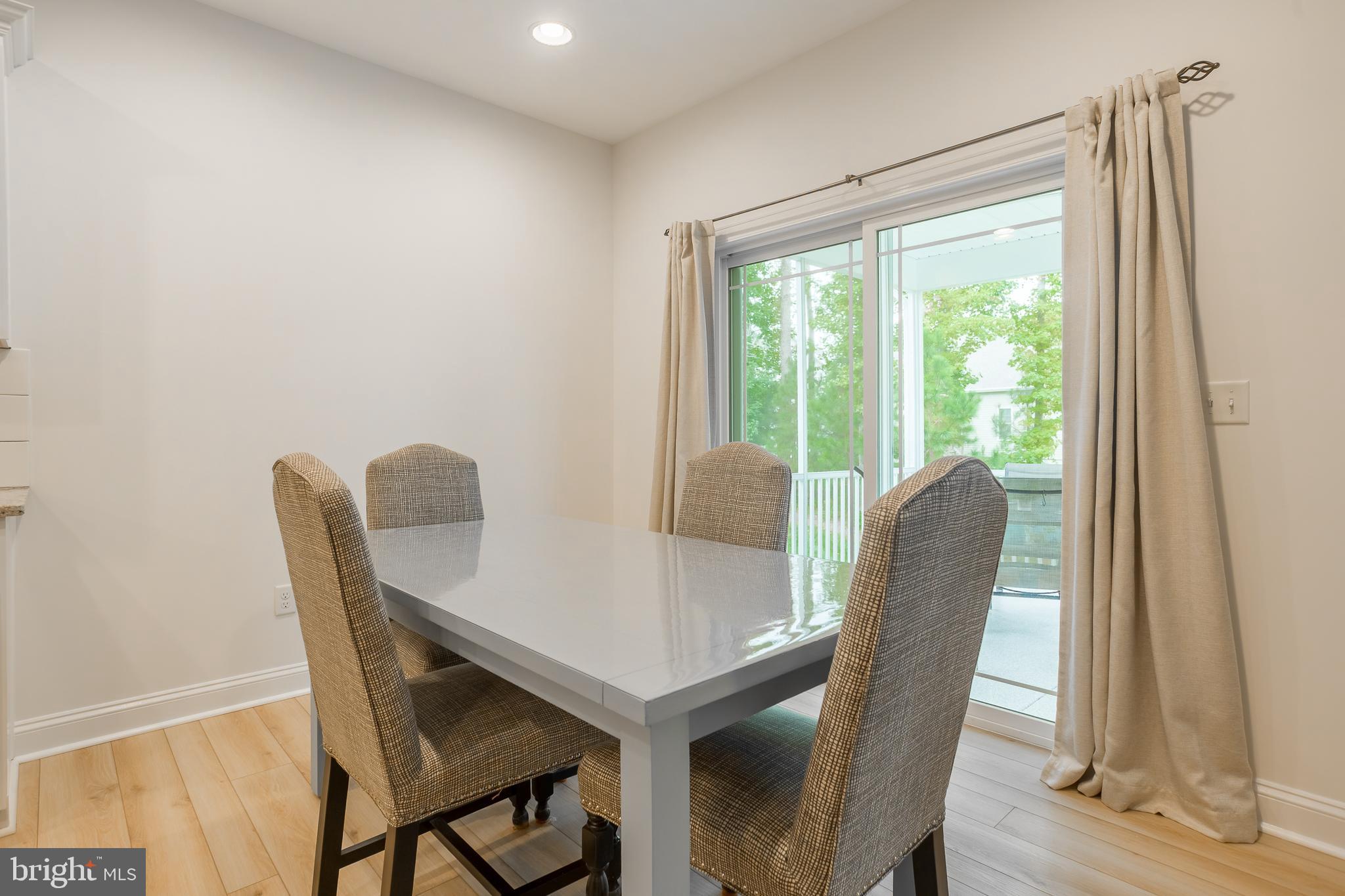 18308 Emerson Way Georgetown, DE 19947 - Photo 13 of 43 a view of a dining room with furniture window and wooden floor