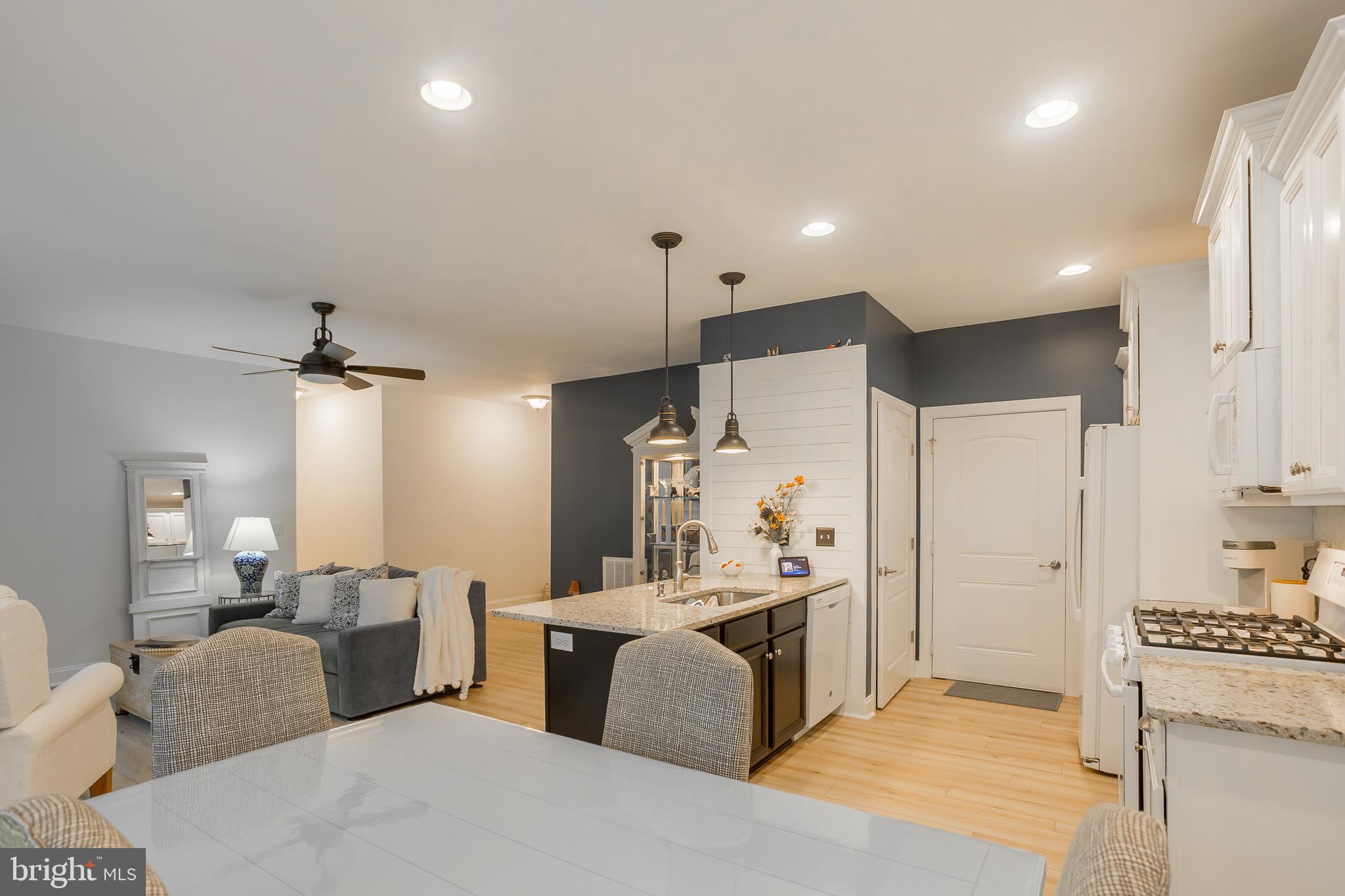 18308 Emerson Way Georgetown, DE 19947 - Photo 14 of 43 a living room with furniture a large window with kitchen view