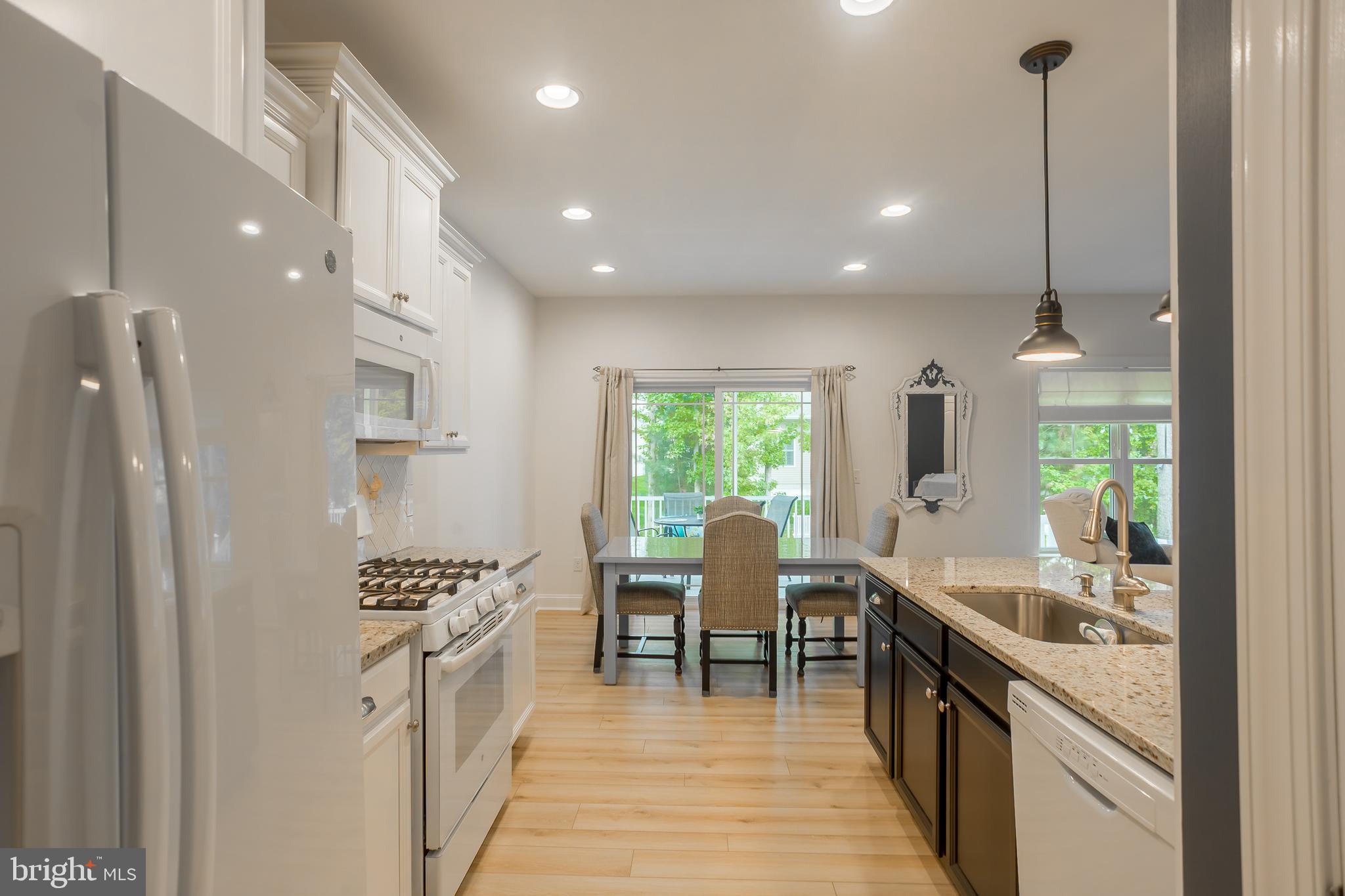 18308 Emerson Way Georgetown, DE 19947 - Photo 18 of 43 a kitchen with sink cabinets and stove