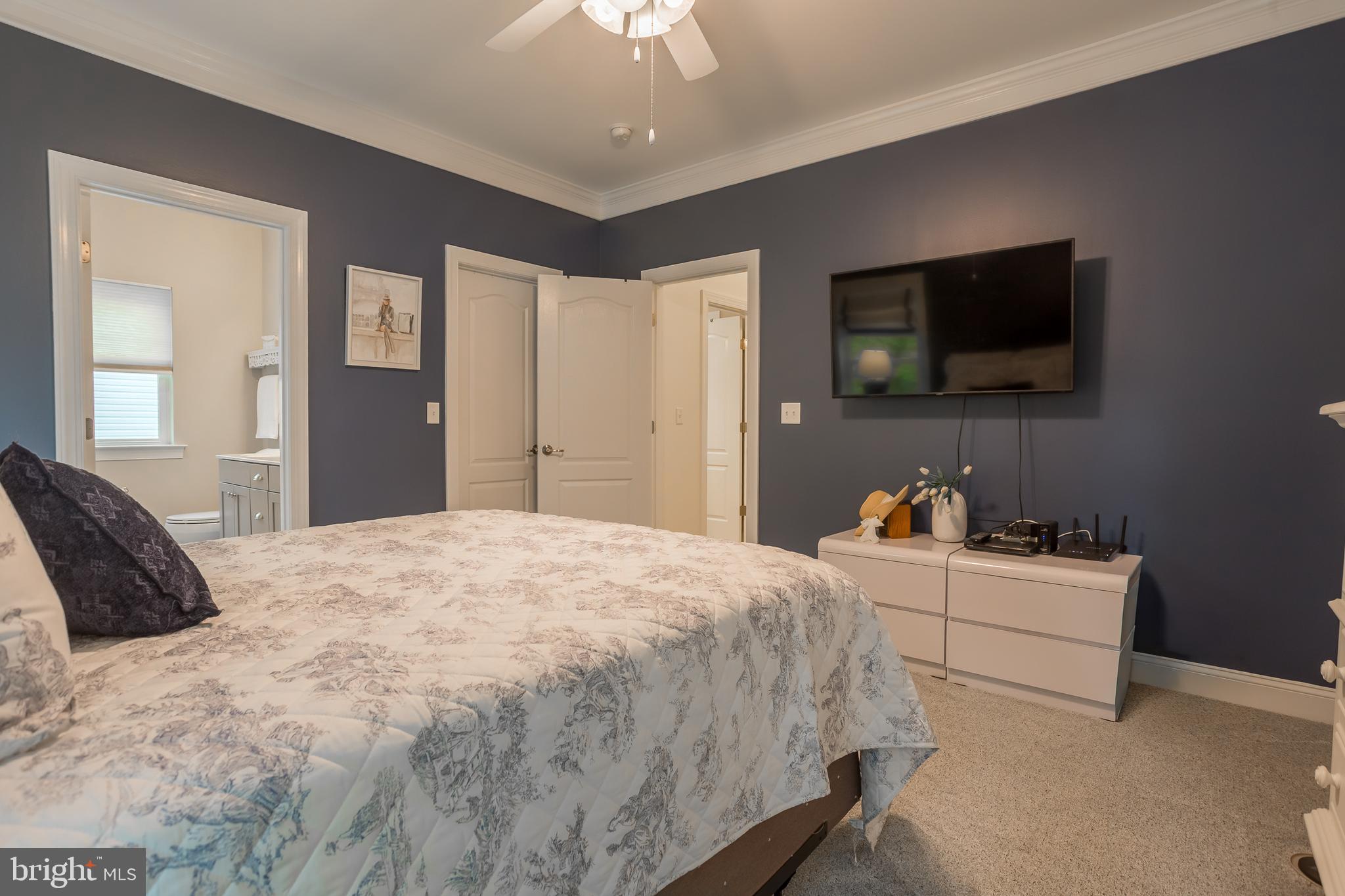 18308 Emerson Way Georgetown, DE 19947 - Photo 25 of 43 a bedroom with a bed and a flat screen tv