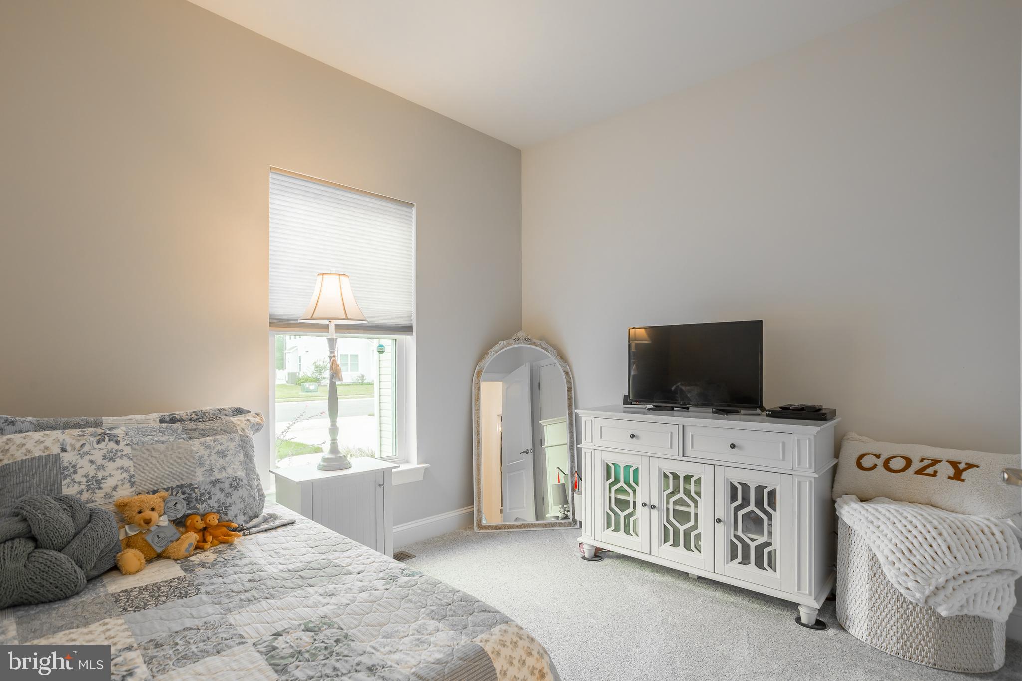18308 Emerson Way Georgetown, DE 19947 - Photo 28 of 43 a bedroom with furniture and a flat screen tv