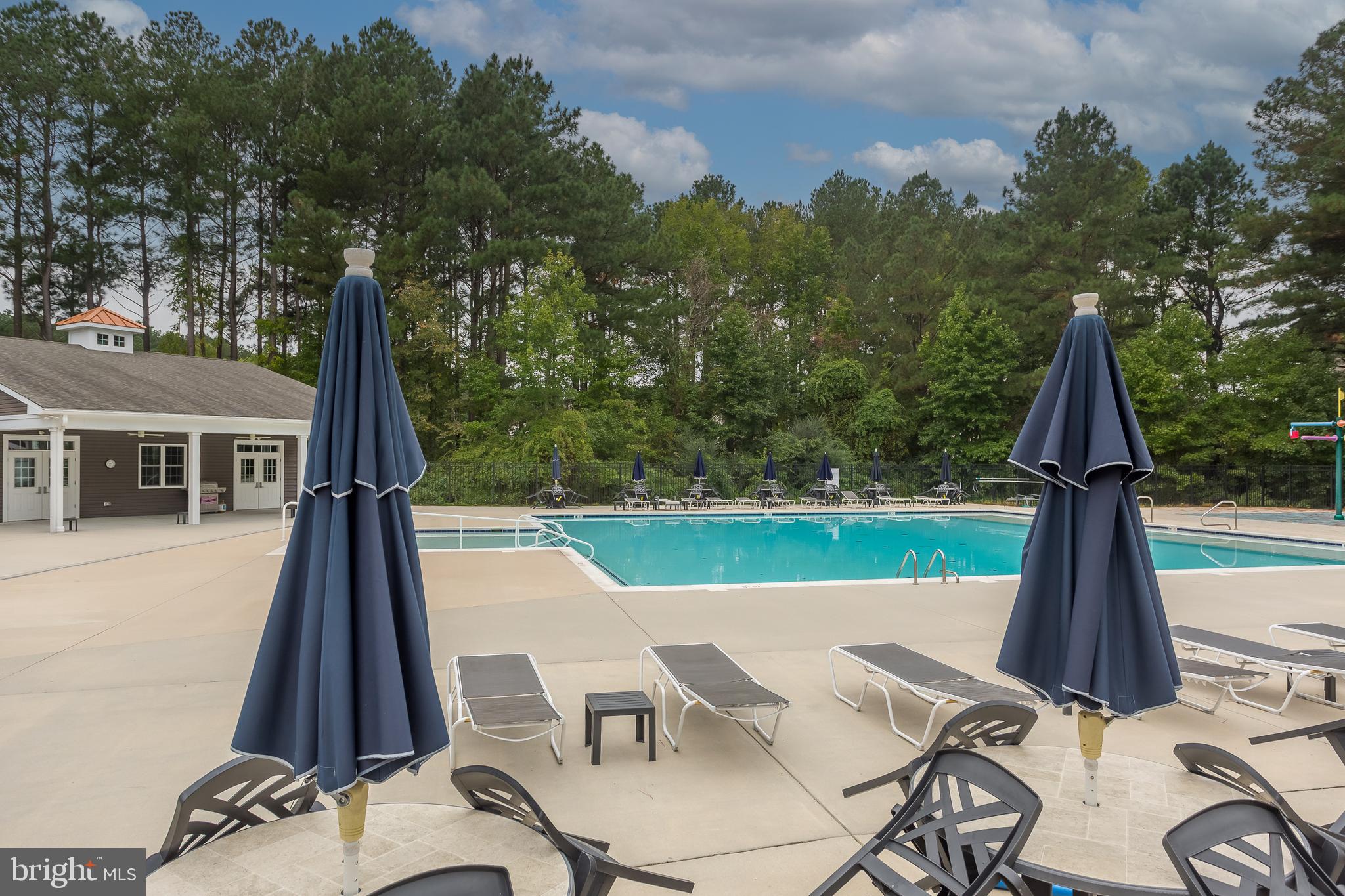 18308 Emerson Way Georgetown, DE 19947 - Photo 40 of 43 a view of a patio with a table chairs and a grill