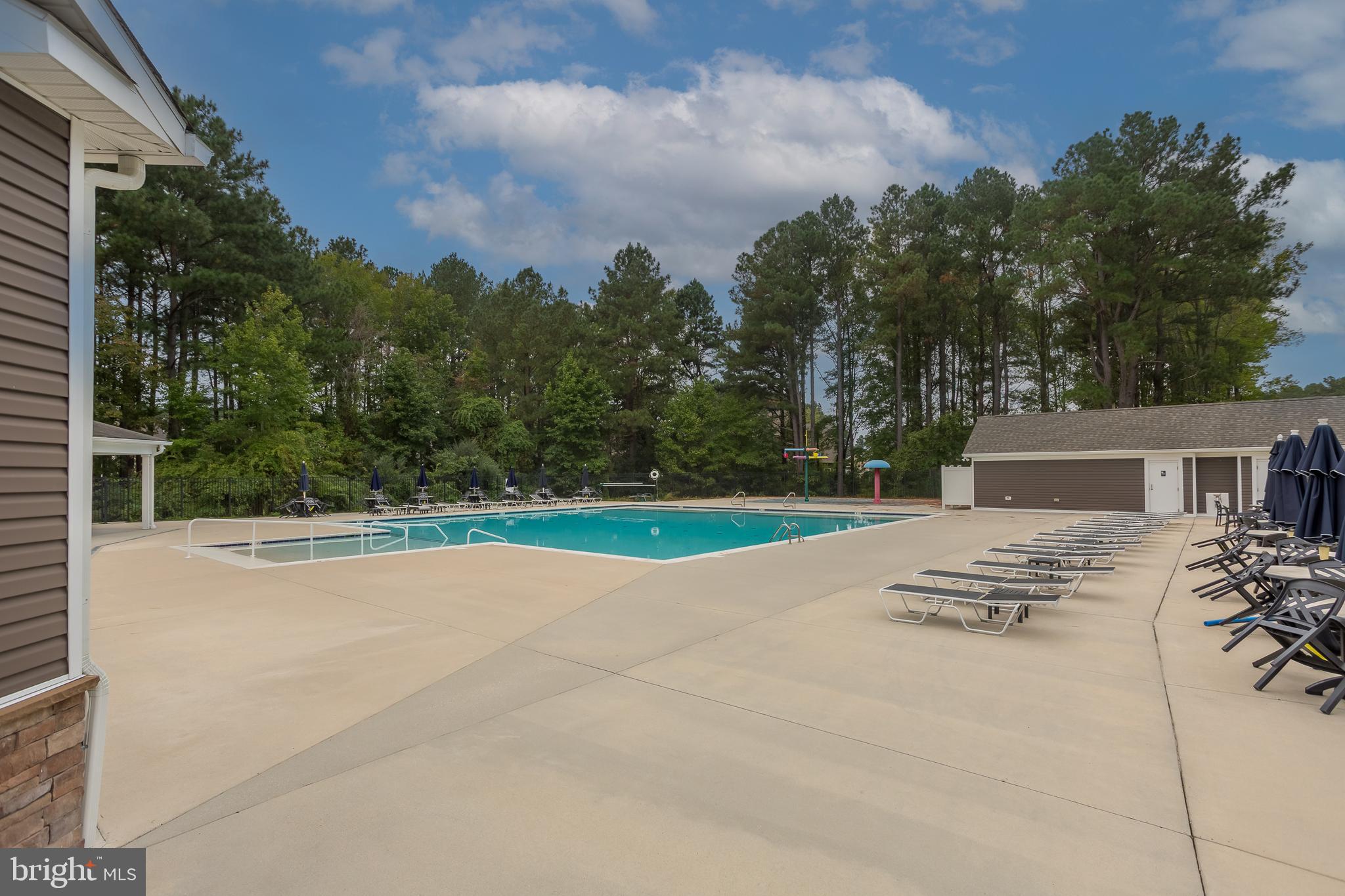 18308 Emerson Way Georgetown, DE 19947 - Photo 41 of 43 a backyard of a house with table and chairs with wooden fence