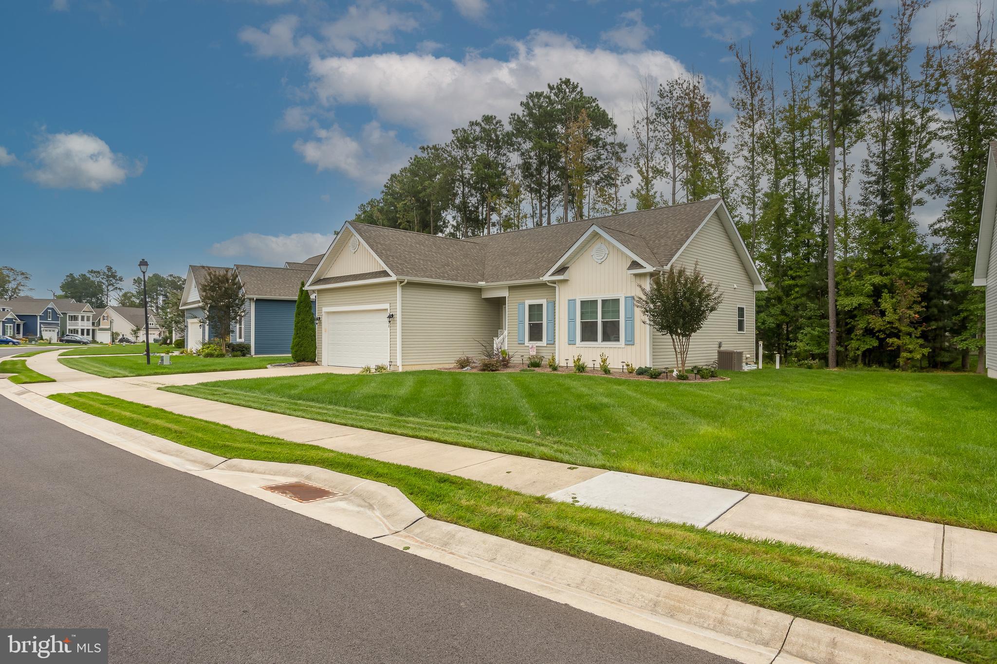 18308 Emerson Way Georgetown, DE 19947 - Photo 7 of 43 a front view of a house with a yard