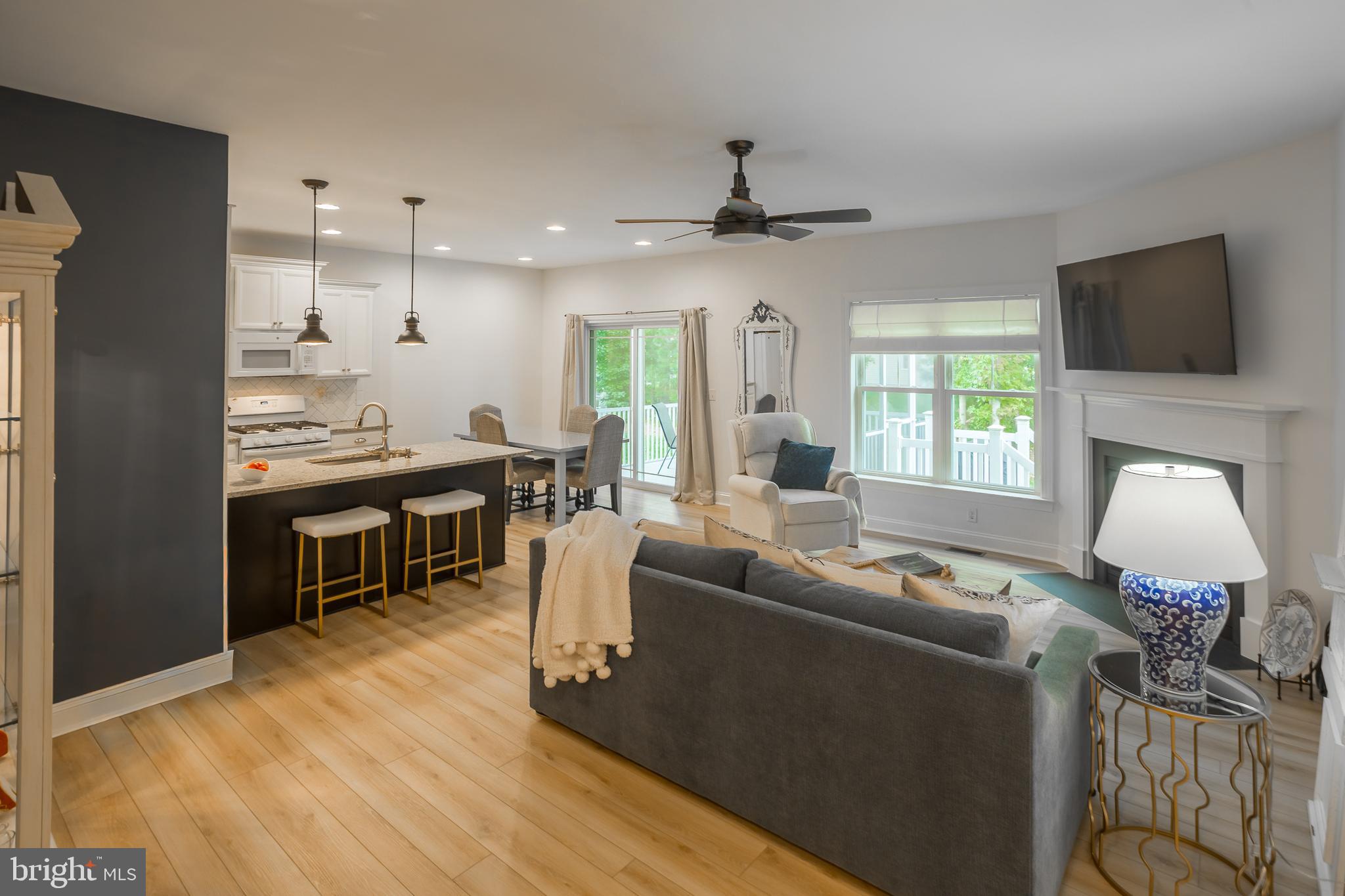 18308 Emerson Way Georgetown, DE 19947 - Photo 10 of 43 a living room with furniture a flat screen tv and kitchen view