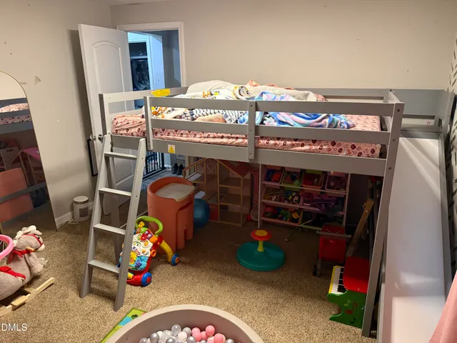 a bedroom with a bed a desk and chair