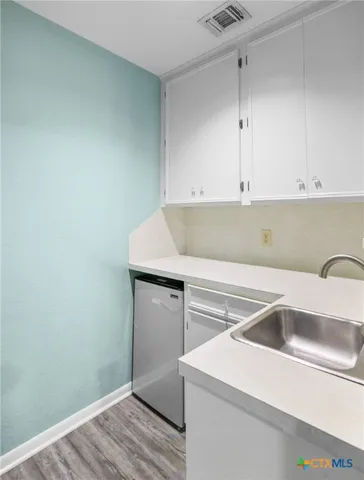 a view of cabinets and wooden floor