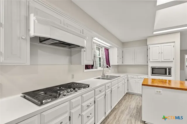 a kitchen with a stove a sink and a refrigerator