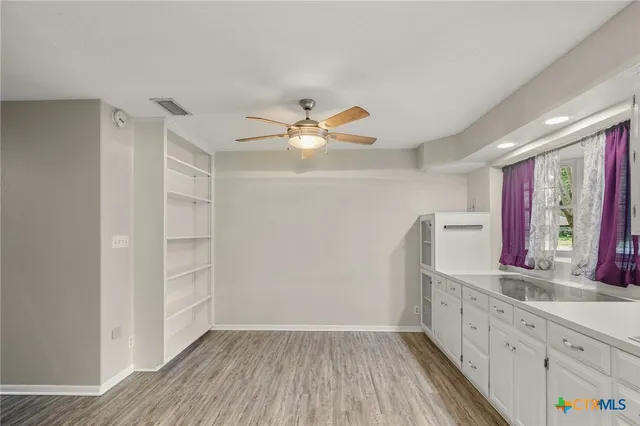 a view of cabinets with wooden floor and entryway