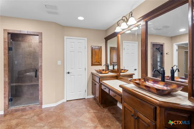 a spacious bathroom with a granite countertop sink and a mirror