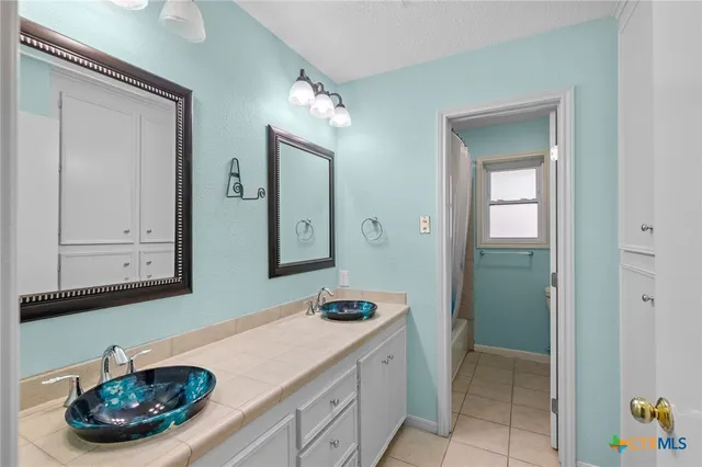 a bathroom with a sink and a mirror