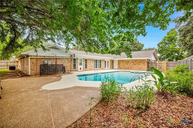 a front view of a house with a garden and porch