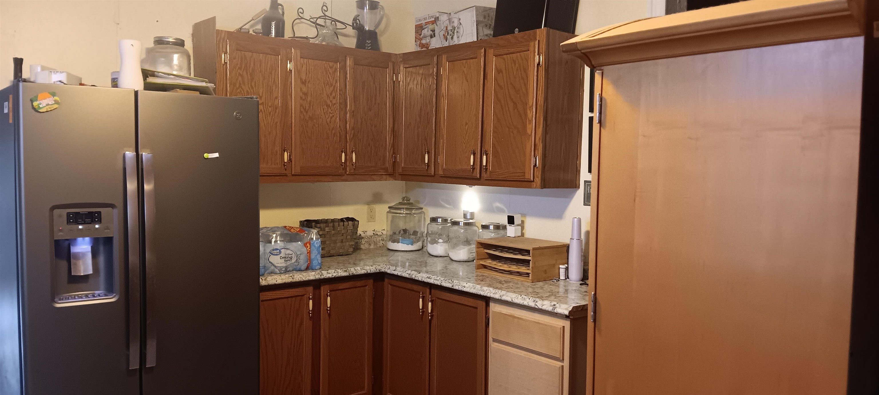 100 Academy Road Pulaski, TN 38478 - Photo 14 of 36 Kitchen featuring stainless steel refrigerator with ice dispenser, brown cabinetry, and light stone counters