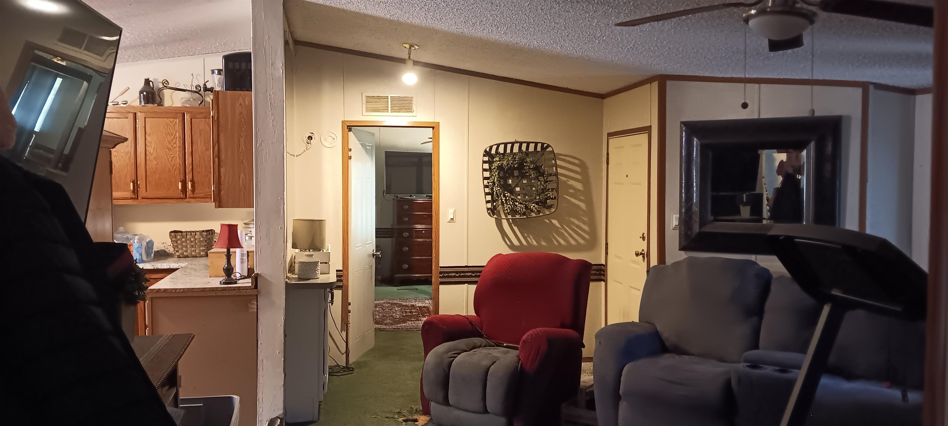 100 Academy Road Pulaski, TN 38478 - Photo 9 of 36 Kitchen featuring a textured ceiling, crown molding, lofted ceiling, light countertops, and brown cabinetry