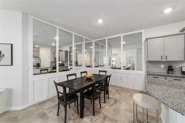 a view of a dining room and kitchen with a table chairs and a sink