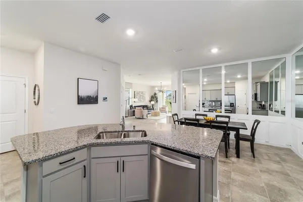 a kitchen with sink stove and dining table
