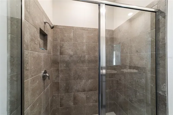 a bathroom with a glass shower door