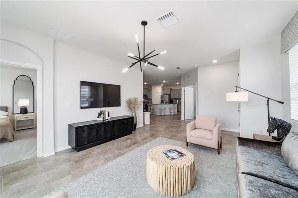 a living room with furniture a rug and a flat screen tv