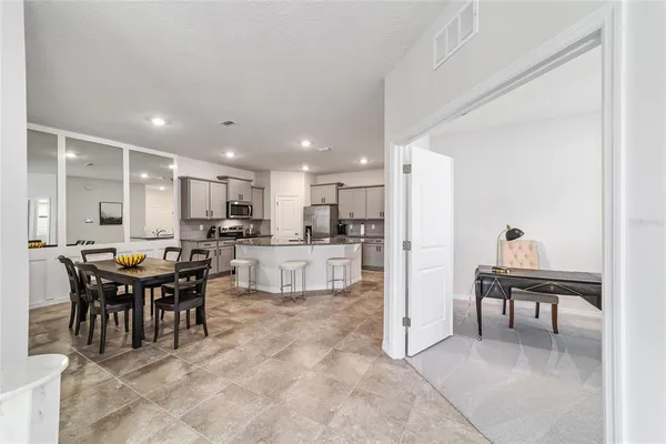 a large kitchen with a table and chairs