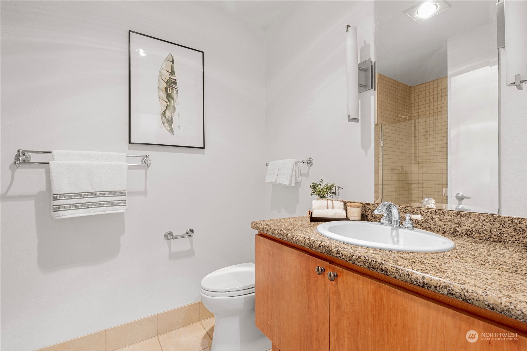 5000 30th Avenue Northeast, Unit 302 Seattle, WA 98105 - Photo 16 of 21 a bathroom with a granite countertop sink mirror vanity and toilet