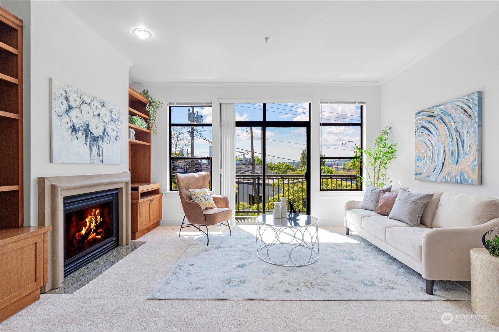 5000 30th Avenue Northeast, Unit 302 Seattle, WA 98105 - Photo 2 of 21 a living room with furniture a floor to ceiling window and a fireplace