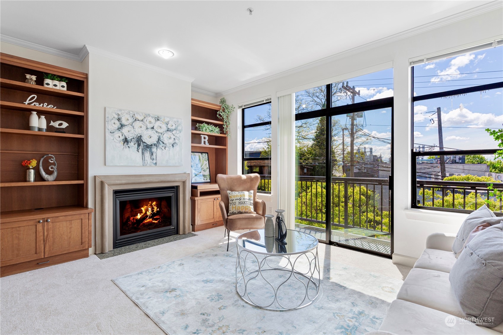 5000 30th Avenue Northeast, Unit 302 Seattle, WA 98105 - Photo 4 of 21 a living room with furniture a fireplace and a floor to ceiling window