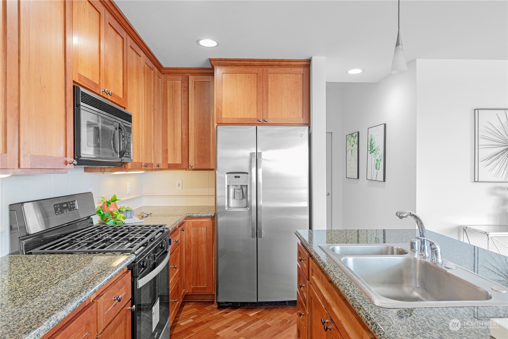 5000 30th Avenue Northeast, Unit 302 Seattle, WA 98105 - Photo 9 of 21 a kitchen with stainless steel appliances granite countertop a sink stove and refrigerator