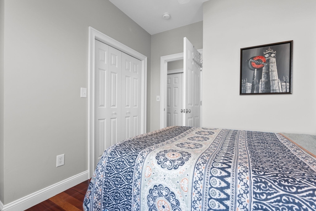 34 H Street, Unit 2L Boston, MA 02127 - Photo 9 of 20 a bedroom with a bed and a painting on the wall