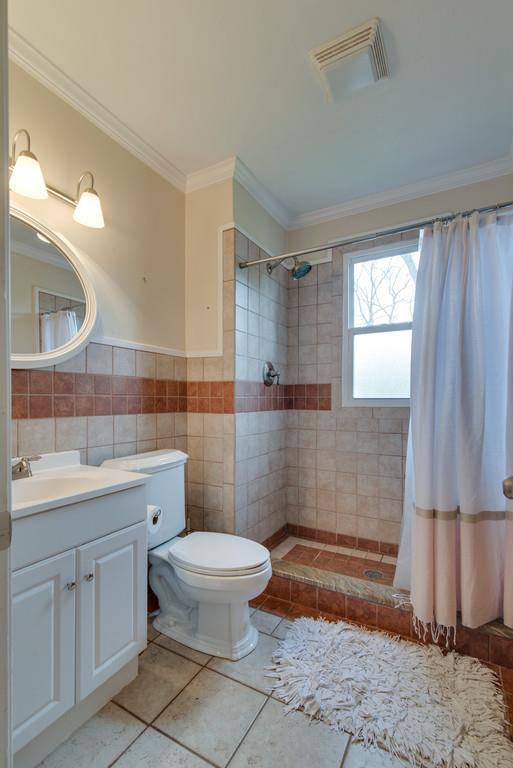 5561 Knob Road Nashville, TN 37209 - Photo 17 of 26 a bathroom with a toilet a sink and mirror