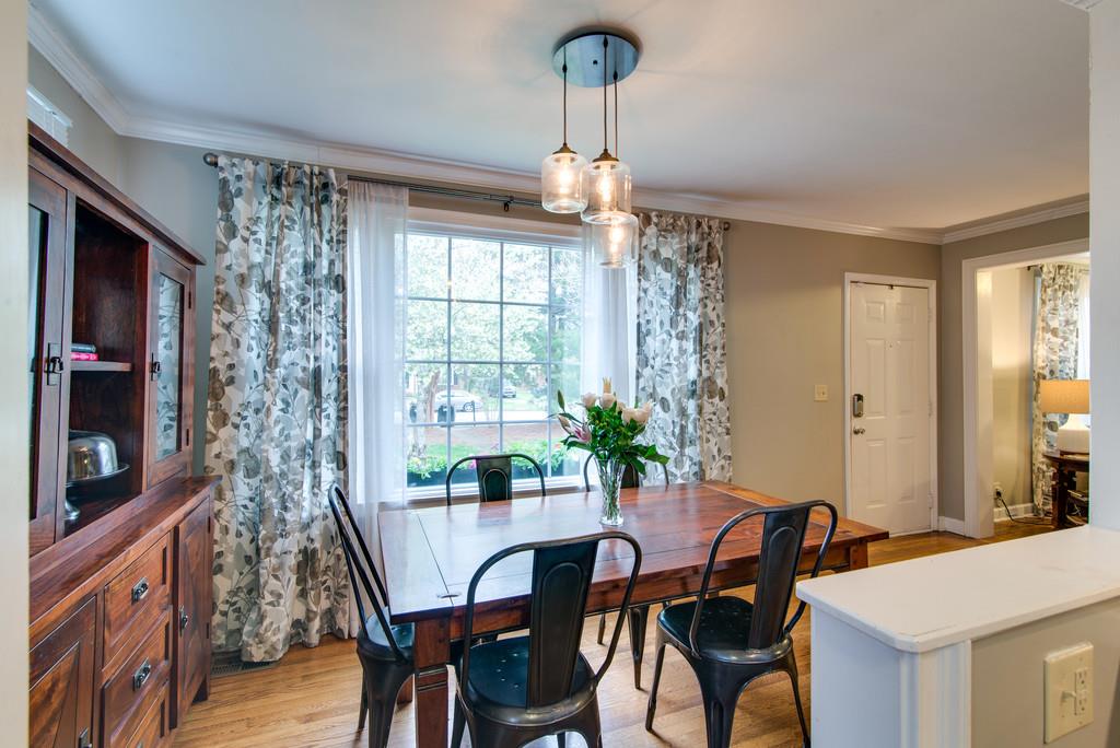 5561 Knob Road Nashville, TN 37209 - Photo 9 of 26 a view of a dining room with furniture window and wooden floor