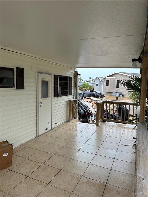 a room with gym equipment and stainless steel appliances