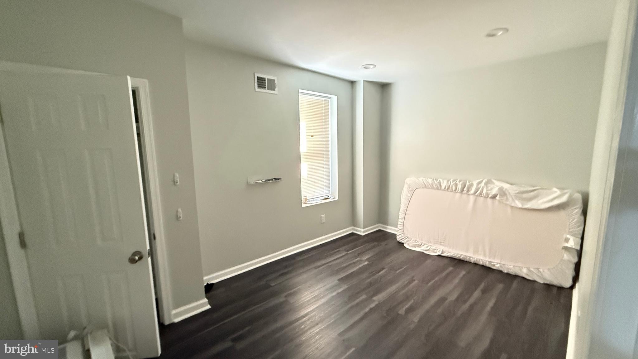 5129 Wakefield Street Philadelphia, PA 19144 - Photo 13 of 17 a view of an empty room with wooden floor and a window