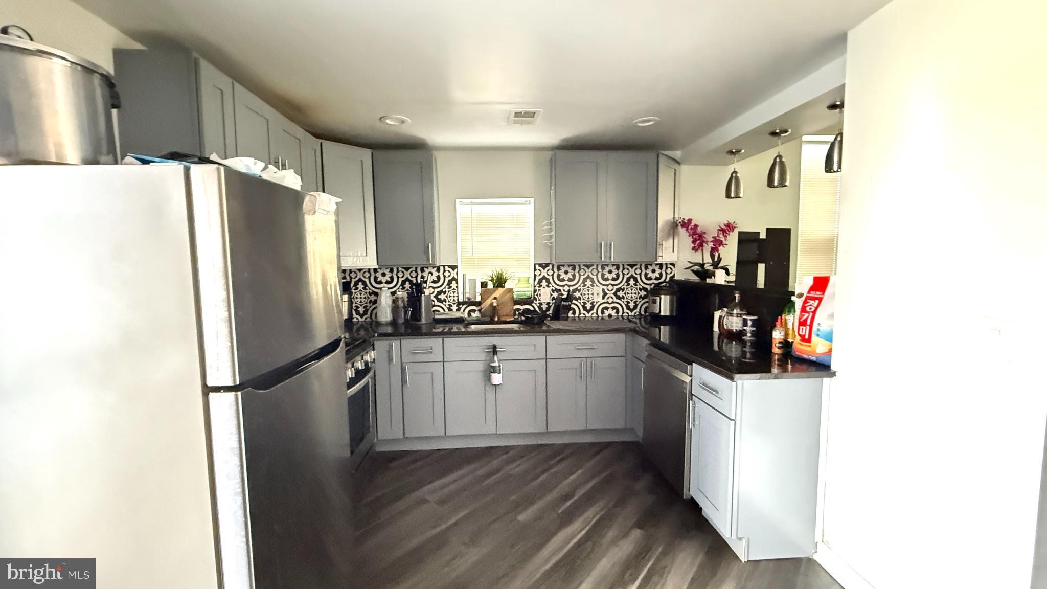 5129 Wakefield Street Philadelphia, PA 19144 - Photo 6 of 17 a kitchen with a refrigerator and a sink