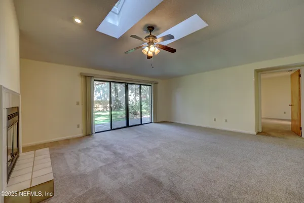 a view of a livingroom with a ceiling fan and window