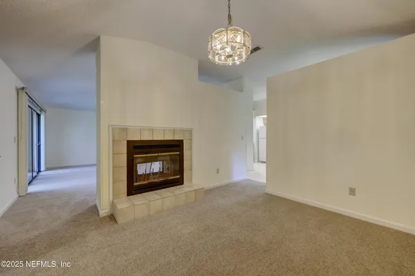 a view of an empty room with a fireplace