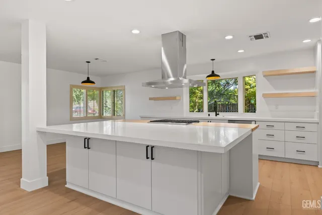 a view of a room with wooden floor and cabinets