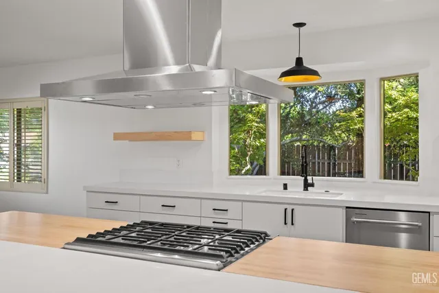 a stove top oven sitting inside of a kitchen