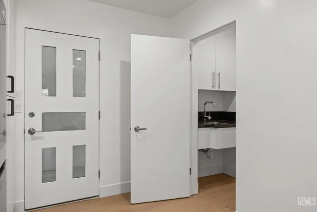 a bathroom with a granite countertop sink toilet and mirror