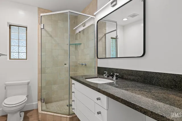 a backyard of a house with table and chairs plants and large trees