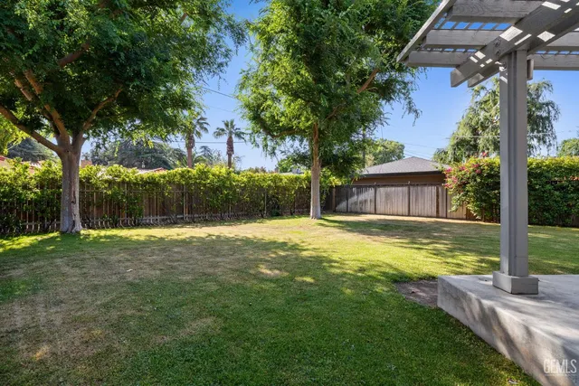 a view of kitchen with kitchen island a sink stainless steel appliances and cabinets