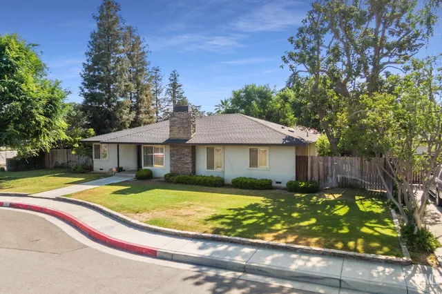 a house that has a tree in front of it