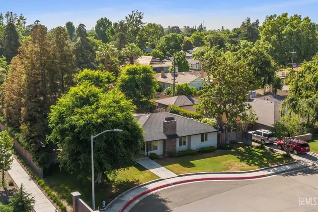 an empty room with a window and a ceiling fan