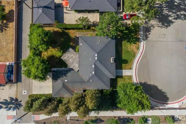 an empty room with a window and a ceiling fan
