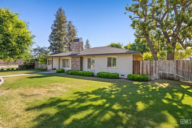 a view of house with outdoor space and swimming pool