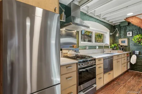 a kitchen with stainless steel appliances granite countertop a stove and a refrigerator