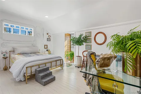 a bedroom with furniture and a window