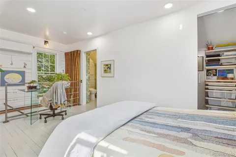 a bedroom with a bed and a potted plant