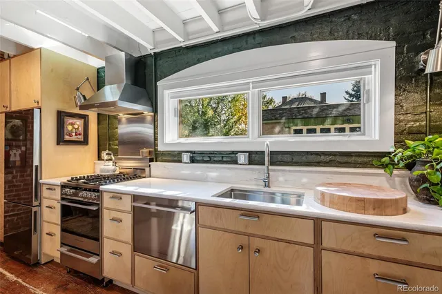 a kitchen with stainless steel appliances a sink and a stove