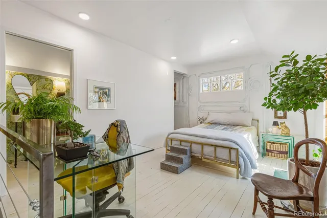 a bedroom with furniture and a potted plant